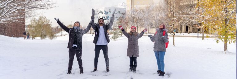 Students at the Keele Campus throwing snow up in the air