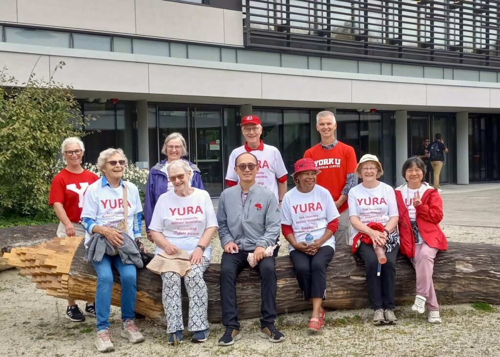 A group photo taken in the courtyard of the Rob and Cheryl McEwen Graduate Study & Research Building.  Back row Sheila Forshaw, Gwyn Buck, Steve Drantisaris, Art McDonald. Seated at front, Claudia Hungerson, Lynn Taylor, Steven Chuang, Agnes Fraser, Diane Woody and Grace Chui