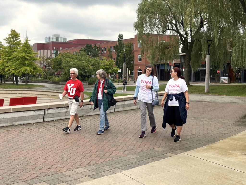 Sheila Forshaw, Marla Chodak, Donna Smith and Debbie Hansen walking by the reflecting pond on the Common