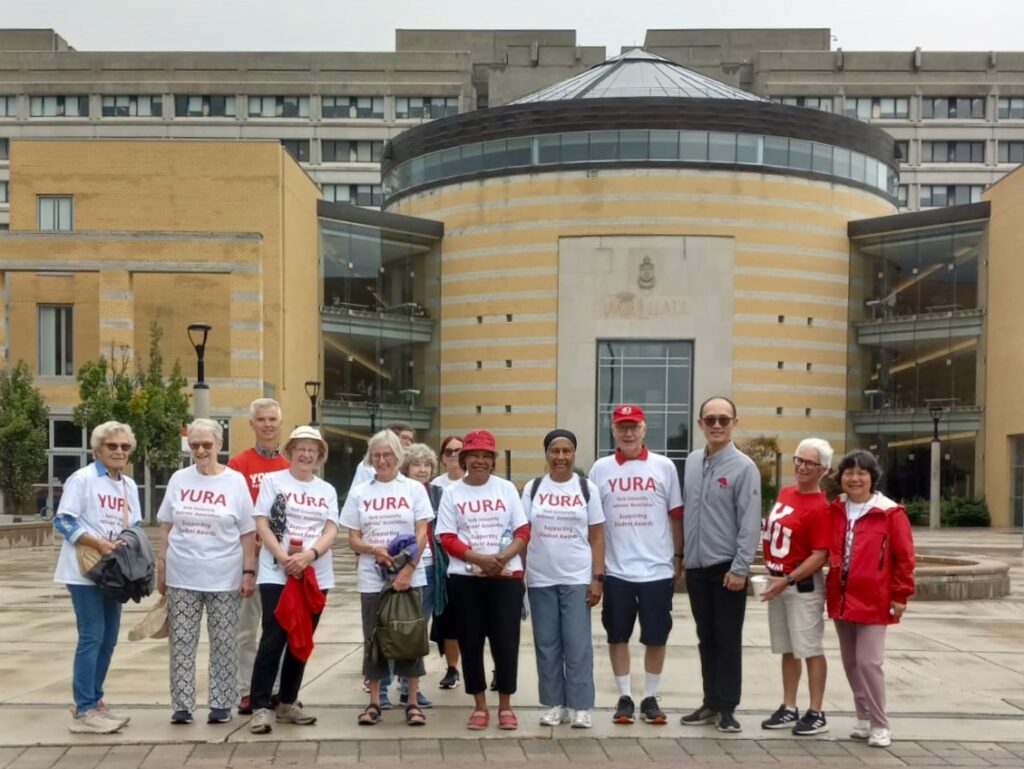 Members of the YURA walking group stop and pose in front of the Vari Hall Rotunda