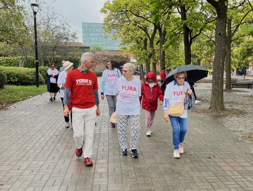 Art McDonald, Lynn Taylor and Claudia Hungerson leading the group walking along the Campus Walk